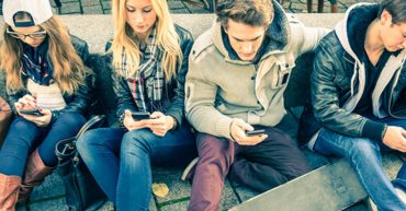 A picture of young students checking their mobile